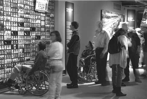 Visitors viewing photo wall at the USHMM
