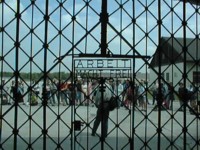 Photo from cover of Professor's book about post-1945 history of Dachau: tourist group seen through concentration camp gate